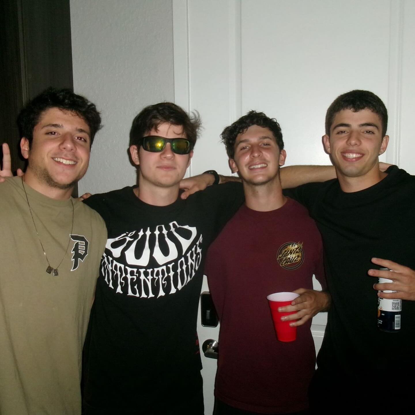 Rafael and three friends posing together indoors