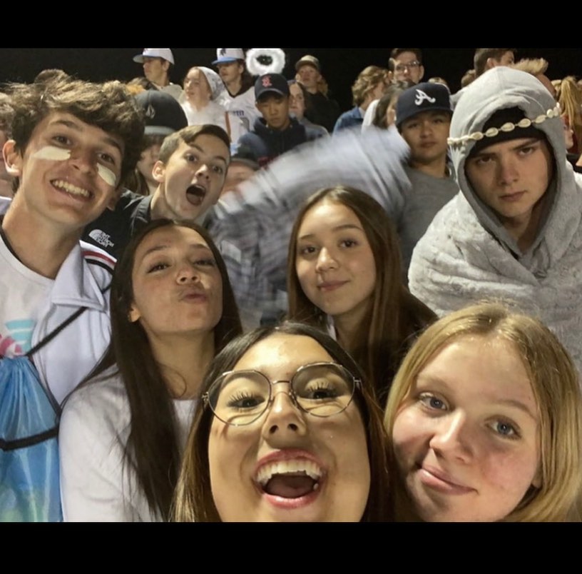 Selfie of a group of friends in the stands at a night game in Idaho